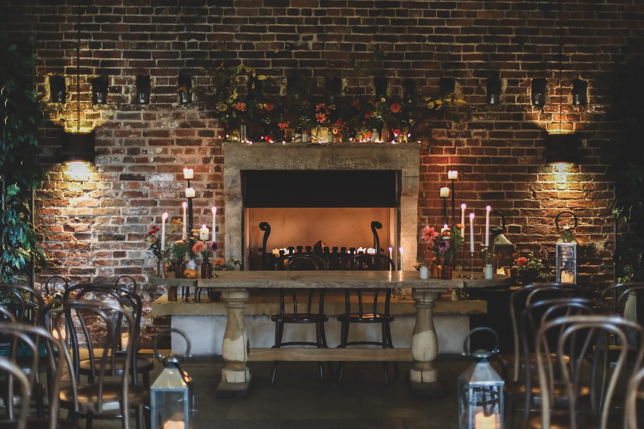 A candlelit wedding table dressed with seasonal flowers
