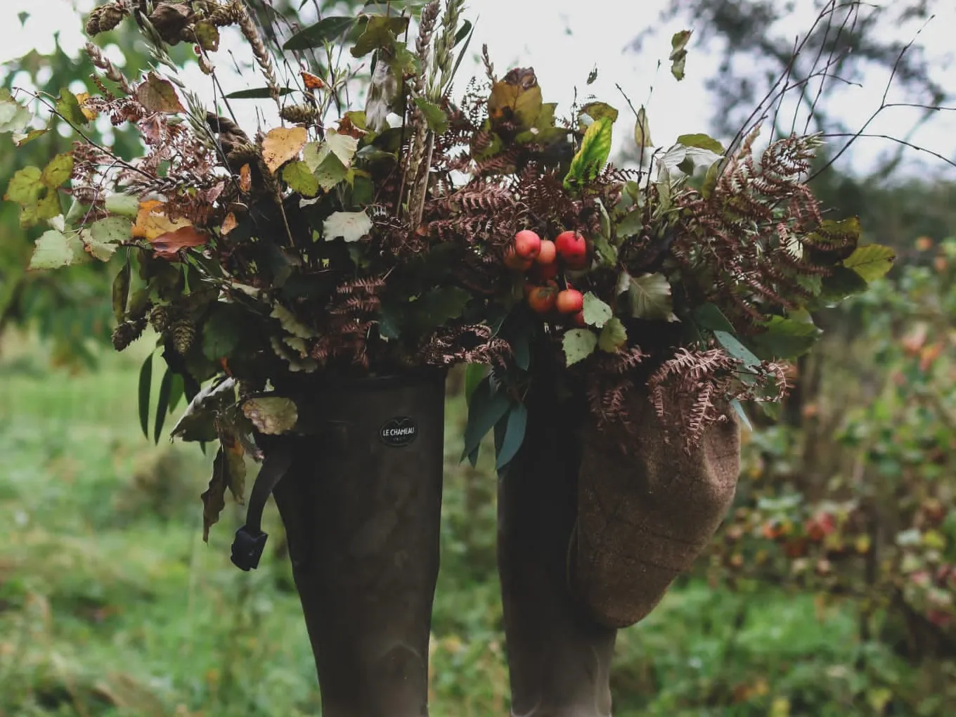 Wellies filled with seasonal funeral flowers, set out as a tribute